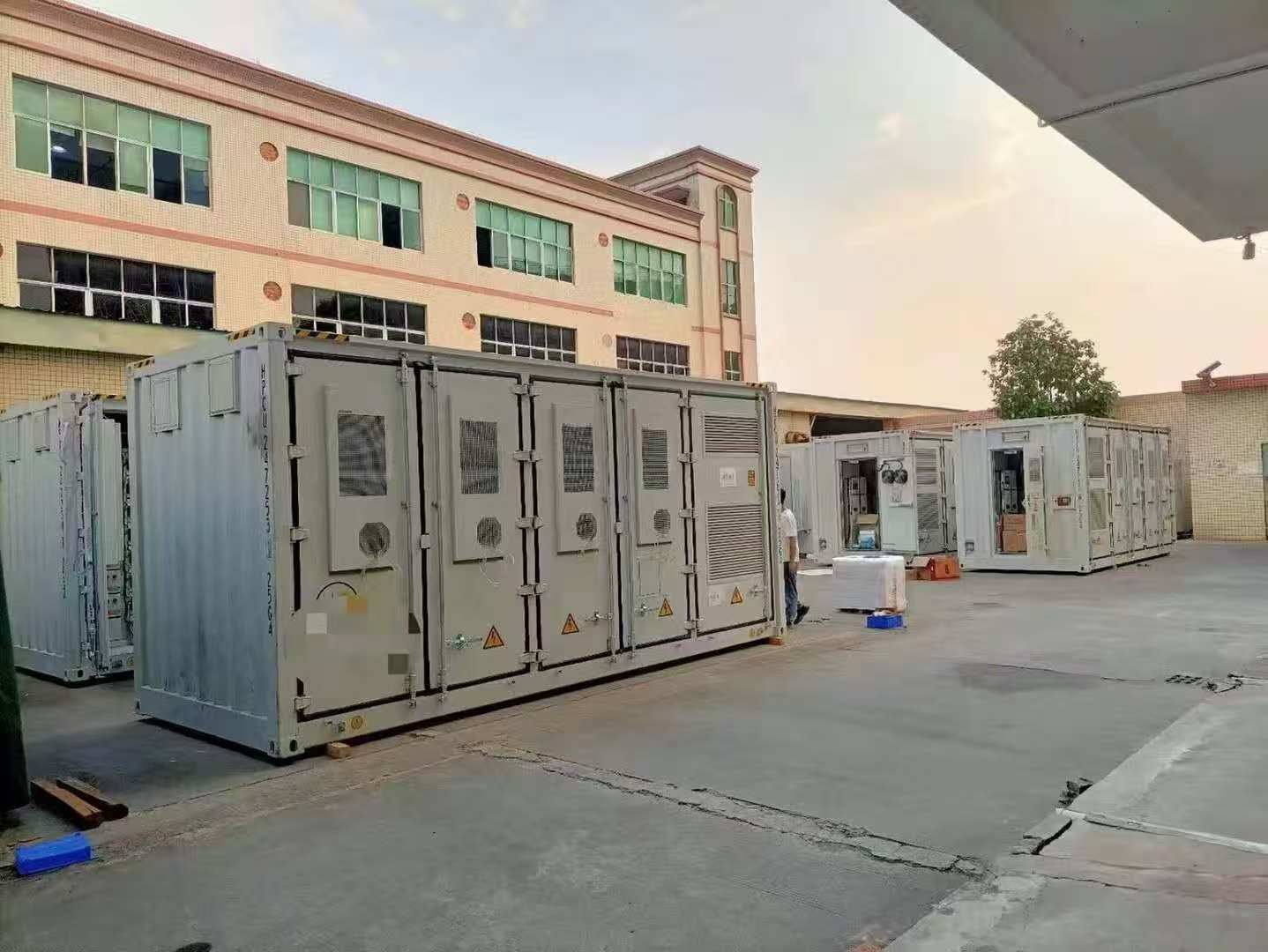 Containerized battery backup equipment undergoing inspection before project delivery